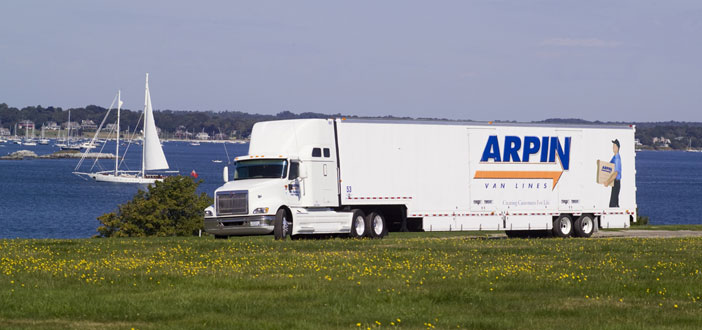 Arpin Van driving in front of lake